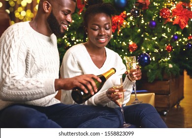 Happy African American Couple Toasting New Year's Eve, Celebrating Winter Holidays At Home Together.