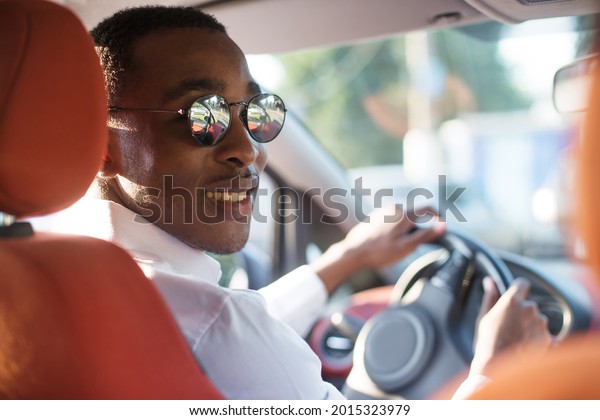 happy
african american driving a car, in the
summer.