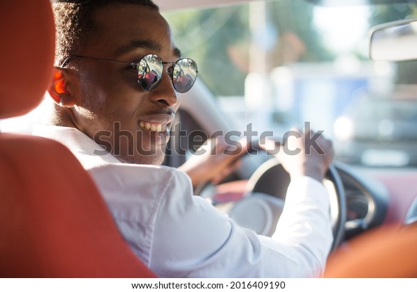 happy
african american driving a car, in the
summer.