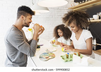 Happy African American Family Coloring Easter Eggs