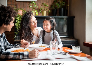 Happy African American Family Eating Lunch Together At Restaurant And Having Fun