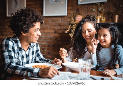 Happy African American Family Eating Lunch Together At Restaurant And Having Fun