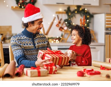 Happy african american family father and kid son pack Christmas gifts - Powered by Shutterstock