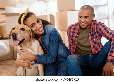 Happy African American Family With Labrador Dog Moving To New Apartment