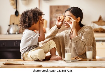 Happy African American Family: Mother And Little Son Eat Cookies With Milk For Breakfast At Home
