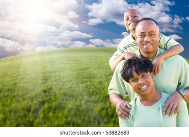 Happy African American Family Over Clouds, Sky And Arched Horizon Of Grass Field.