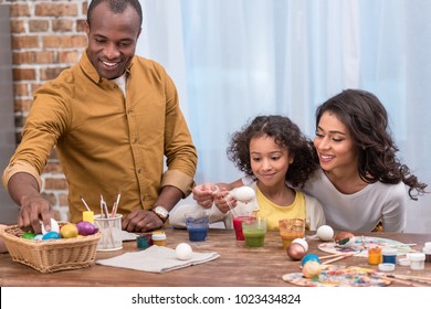 Happy African American Family Painting Easter Eggs