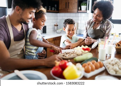 Happy African American Family Preparing Healthy Food Together In Kitchen