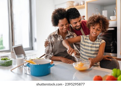 Happy african american family preparing healthy food in kitchen, having fun together on weekend - Powered by Shutterstock