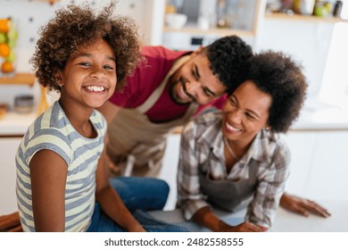 Happy african american family preparing healthy food in kitchen, having fun together on weekend - Powered by Shutterstock