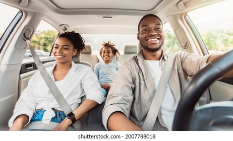 Happy African American Family Riding Car Traveling By Automobile. Black Parents And Daughter Enjoying Summer Road Trip Together On Weekend. Panorama, Selective Focus - Shutterstock ID 2007788018