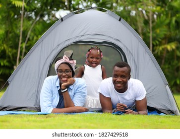 Happy African American family spending time together during vacation on the camping tent outdoor national park - Powered by Shutterstock