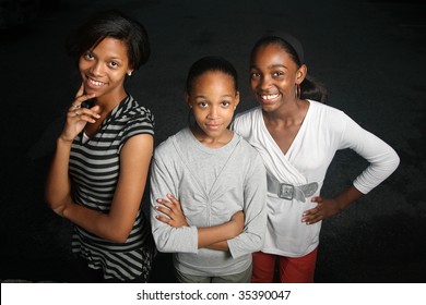 Happy African American Family. Three Teenage Sisters Together Looking At Camera, Smiling.