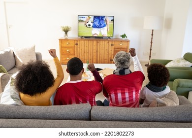 Happy African American Family Watching Football Match Together And Sitting On The Couch. Football, Competition, Cheering And Spending Time Together.