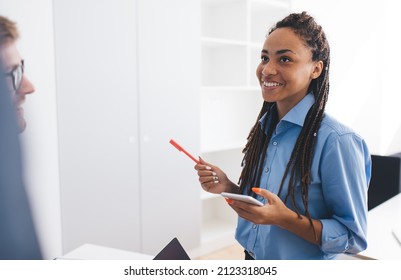 Happy African American female employee with smartphone gadget communicate with colleagues enjoying time for together briefing in office interior, cheerful woman with cellphone discussing business - Shutterstock ID 2123318045