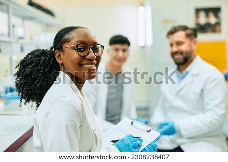 Happy African American female scientist during a research in laboratory looking at camera. ストックフォト © 