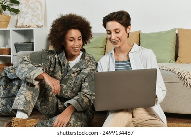 happy african american female soldier and her girlfriend using laptop, homecoming, lesbian couple - Powered by Shutterstock