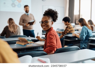 Happy African American female student on a class at the university looking at camera. - Powered by Shutterstock