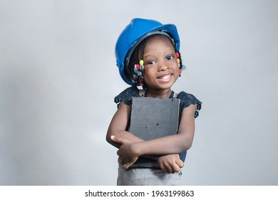 Happy African American girl with blue helmet or hard hat hugging educational books indoor as education grows intelligence and knowledge which can be gotten from studying reading and learning 