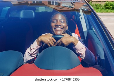 The Happy African American Girl In The Car