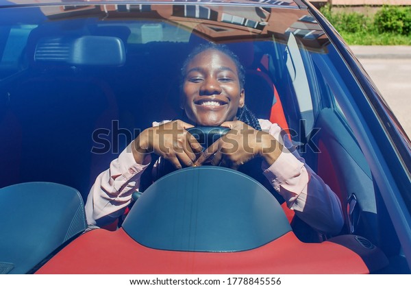the Happy African\
American girl in the car