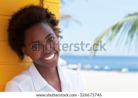 Happy african american girl near beach