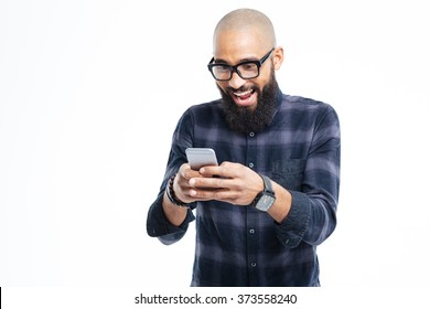 Happy african american hairless man with beard smiling and using mobile phone