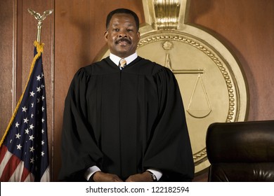 Happy African American Judge Standing In Courtroom