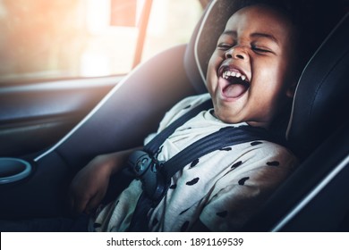 Happy African American Kid In A Car Seat