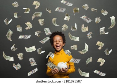 Happy African American Kid Laughing And Holding White Piggy Bank In American Dollar Money Rain On Black Background