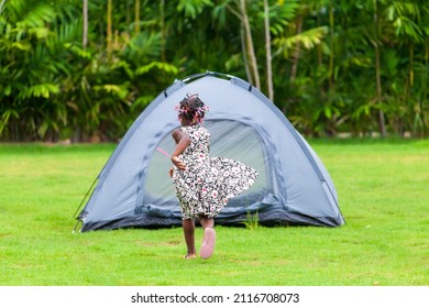 Happy African American Kid Spending Fun Time During Vacation On The Camping Tent Outdoor At National Park In The Forest