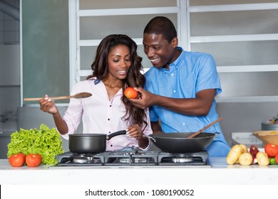 Happy African American Love Couple Cooking At Kitchen At Home