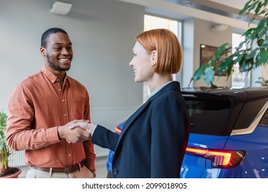 Happy African American Man And Car Dealer Shaking Hands Near Car