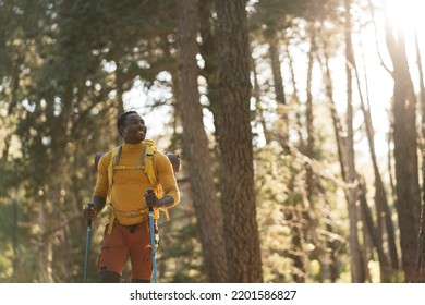 Happy African American Man In Forest At Sunset - Hiker With Backpack Celebrating Success Outdoors - People, Success And Sport Concept