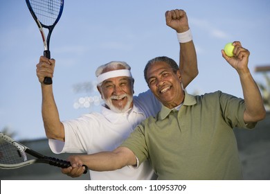 Happy African American man with a friend playing tennis - Powered by Shutterstock