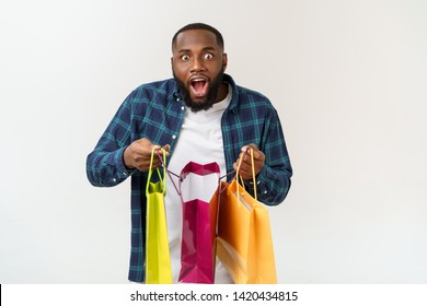 Happy African American Man Holding Shopping Bags On White Background. Holidays Concept