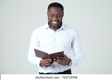 Happy African American Man Reading Book. Smiley Face.