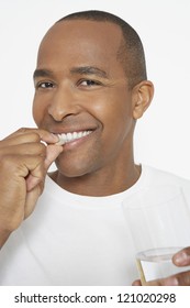 Happy African American Man Taking Pill