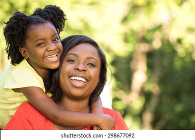 Happy African American Mother And Daughters.