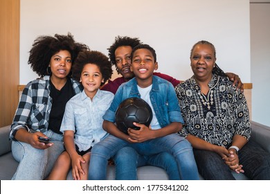 Happy African American Multi-generation Family Watching Soccer Match On Television In Living Room At Home. Family And Sport Concept.