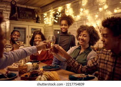 Happy African American multigeneration family toasting while celebrating Thanksgiving at dining table. - Powered by Shutterstock