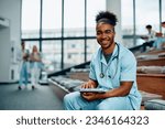 Happy African American nursing student studying at medical university and looking at camera. 