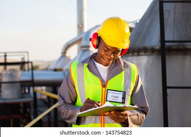 Happy African American Oil Chemical Industry Worker Working In Plant