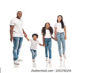 happy african american parents holding hands with daughter and son while standing on white background
