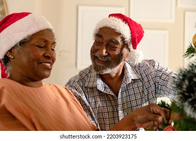 Happy african american senior couple decorating christmas tree. family christmas time and festivity together at home. - Powered by Shutterstock