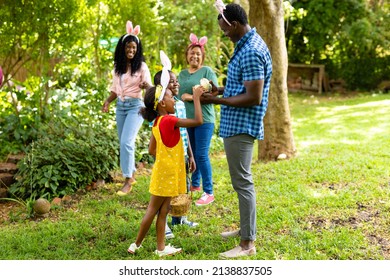 Happy african american siblings wearing bunny ears with family in backyard on easter day. unaltered, lifestyle, easter day, celebration, childhood, cultures and holiday concept. - Shutterstock ID 2138837505