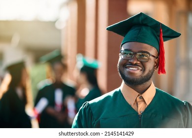Happy African American Student Day Dreaming On His Graduation Day And Looking Away. 