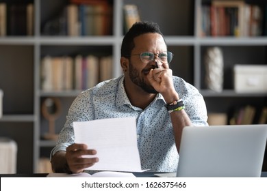 Happy african american student worker winner feel glad receive good news in paper post mail admission letter feel glad about bank loan approval get new job opportunity concept sit at home office desk - Shutterstock ID 1626375466