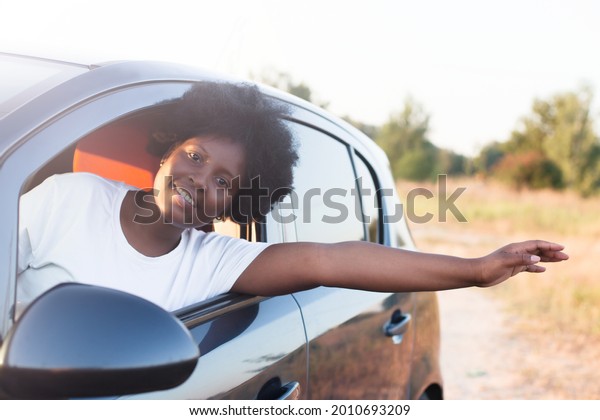 happy african\
american woman in a car,\
lifestyle.