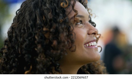 Happy African American Woman Closeup Face Looking Up At Sky Smiling. One Hopeful Black Hispanic 20s Adult Girl